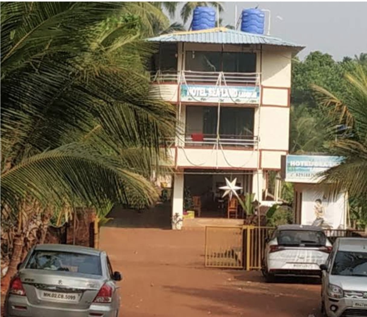 Hotel Sealand entrance and parking among coconut palms