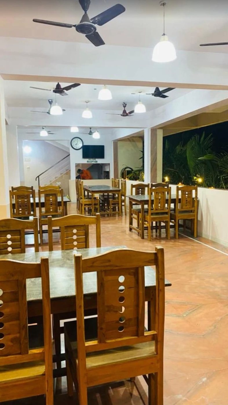 Family restaurant with wooden tables beside the garden