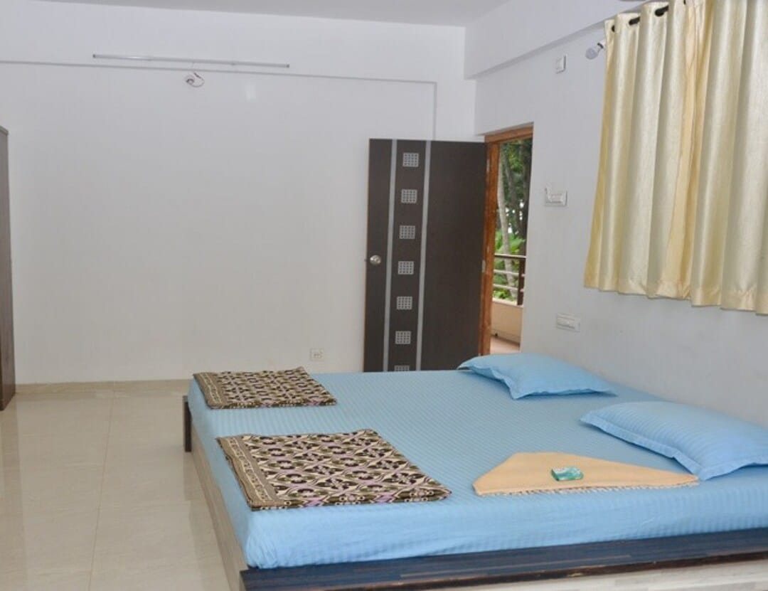 Spacious non-AC room with blue linen double bed